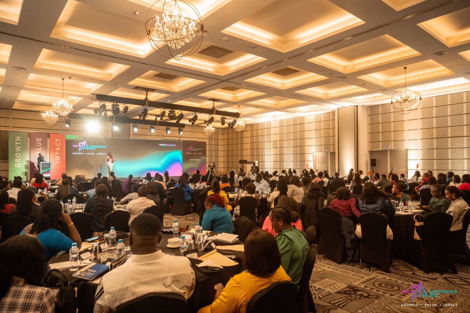 A full hall of delegates facing the main stage