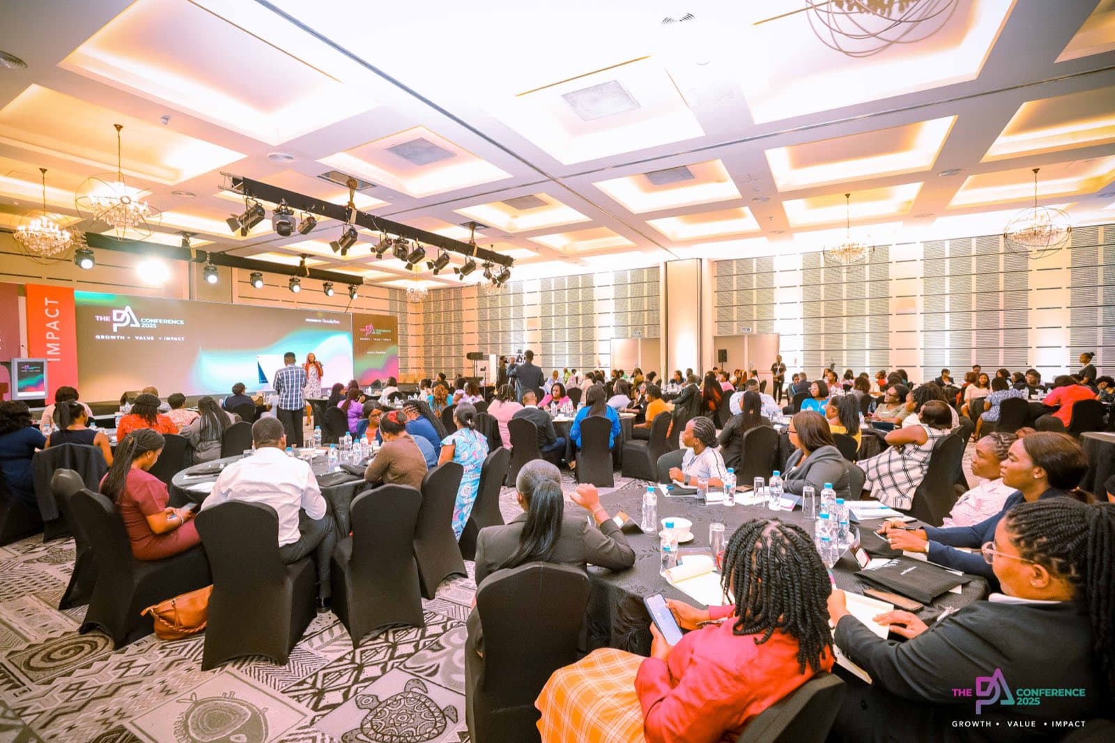 Delegates at their tables during a conference session